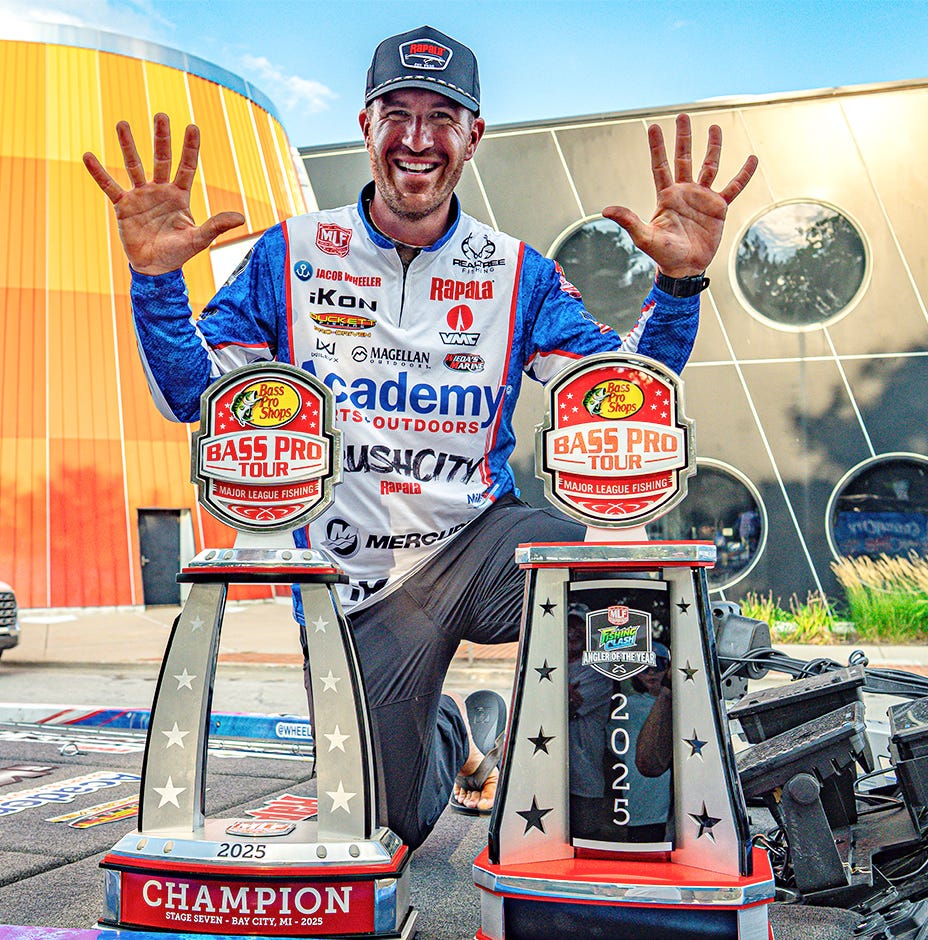 jacob wheeler with his 2025 angler of the year trophies wearing a late 80s Rapala hat
